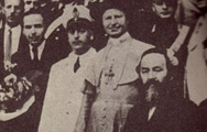 A rabbi, priest, and police officer on the steps of San Bartolomeo Concentration Camp in Campagna, Italy.